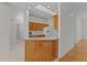 Bright kitchen featuring wooden cabinetry, white countertops, and a practical breakfast bar area at 95 Hickory Loop, Ocala, FL 34472