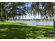 Scenic lake view with mature trees draped in Spanish moss, highlighting the property's natural beauty at 95 Hickory Loop, Ocala, FL 34472