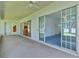 Spacious covered lanai offering views of the lake and multiple access points at 95 Hickory Loop, Ocala, FL 34472