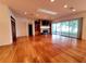 Open-concept living room with hardwood floors, fireplace, built-in shelves, and natural light at 95 Hickory Loop, Ocala, FL 34472