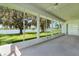 A screened sunroom offers serene lake views through large windows, with multiple ceiling fans for air circulation at 95 Hickory Loop, Ocala, FL 34472