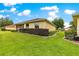 Backyard features lush lawn, manicured shrubs, and screened lanai at 9551 Sw 92Nd Ter, Ocala, FL 34481