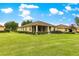 Green lawn, well kept bushes, and a screened lanai make for great outdoor living at 9551 Sw 92Nd Ter, Ocala, FL 34481