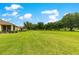 Expansive backyard with lush green lawn and mature trees, perfect for outdoor activities at 9551 Sw 92Nd Ter, Ocala, FL 34481
