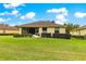 Spacious backyard with green lawn, covered patio and well-maintained landscaping at 9551 Sw 92Nd Ter, Ocala, FL 34481