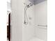 Bathroom includes an updated shower with two shower heads and white tiles at 9551 Sw 92Nd Ter, Ocala, FL 34481