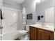 Bathroom with a shower and tub combination and a dark wood sink vanity at 9551 Sw 92Nd Ter, Ocala, FL 34481