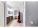 Bathroom with a double vanity, tile floor, and doorway to bedroom with bed in view at 9551 Sw 92Nd Ter, Ocala, FL 34481