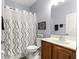 Bathroom features a sink vanity with drawers and a shower-tub with curtain at 9551 Sw 92Nd Ter, Ocala, FL 34481