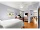Calm bedroom with hardwood floors, white walls, and a cozy bed at 9551 Sw 92Nd Ter, Ocala, FL 34481