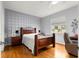 Bedroom features a ceiling fan, wood floors, and a window with natural light at 9551 Sw 92Nd Ter, Ocala, FL 34481