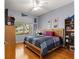 Bedroom with a window, ceiling fan, and built-in bookshelf and decorations at 9551 Sw 92Nd Ter, Ocala, FL 34481