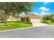 Charming single-story home with well-maintained landscaping, lush green lawn, and attached garage at 9551 Sw 92Nd Ter, Ocala, FL 34481