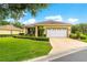 Charming one-story home features a well-manicured lawn, two car garage, and beautiful landscaping at 9551 Sw 92Nd Ter, Ocala, FL 34481