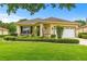 Charming single-story home with well-maintained landscaping and a lush green lawn at 9551 Sw 92Nd Ter, Ocala, FL 34481
