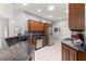 Well-lit kitchen with dark countertops, stainless steel appliances, and dark wood cabinetry at 9551 Sw 92Nd Ter, Ocala, FL 34481