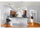 Modern kitchen with dark wood cabinetry, granite countertops, and stainless steel appliances at 9551 Sw 92Nd Ter, Ocala, FL 34481