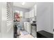 Efficient laundry room with washer, dryer, storage cabinets, and shelving at 9551 Sw 92Nd Ter, Ocala, FL 34481