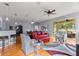 Bright living room with hardwood floors, a ceiling fan, and glass sliding doors to a lanai at 9551 Sw 92Nd Ter, Ocala, FL 34481