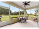 Inviting screened patio with ceiling fan and views of the lush backyard and golf course at 9551 Sw 92Nd Ter, Ocala, FL 34481