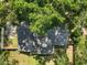 An aerial view showcases the roof and yard, surrounded by mature trees at 986 Se 57Th Ave, Ocala, FL 34480