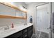 Elegant bathroom featuring double sinks, a framed mirror, and a glass-enclosed shower at 986 Se 57Th Ave, Ocala, FL 34480