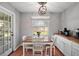 Cozy dining area with natural light, featuring a wooden table and white chairs at 986 Se 57Th Ave, Ocala, FL 34480