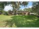 Well-maintained home features a brick and siding exterior, a green lawn and a cozy porch with rocking chairs at 986 Se 57Th Ave, Ocala, FL 34480