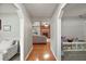 Hallway view leading into the living room with a brick fireplace, hardwood flooring, and neutral paint at 986 Se 57Th Ave, Ocala, FL 34480