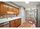 Bright kitchen featuring wooden cabinets and stainless steel appliances, adjacent to a dining area at 986 Se 57Th Ave, Ocala, FL 34480
