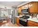 Well-lit kitchen showcasing stainless steel appliances and wooden cabinets at 986 Se 57Th Ave, Ocala, FL 34480