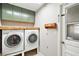 Well-equipped laundry room with overhead cabinets, a wood countertop, and a utility sink at 986 Se 57Th Ave, Ocala, FL 34480