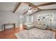 Inviting living room featuring high ceilings with exposed beams and a cozy sectional sofa at 986 Se 57Th Ave, Ocala, FL 34480