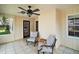 Cozy screened patio with comfortable seating and a ceiling fan, perfect for relaxing outdoors at 986 Se 57Th Ave, Ocala, FL 34480