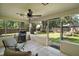 Inviting screened patio with a grill and view of the backyard, perfect for outdoor gatherings at 986 Se 57Th Ave, Ocala, FL 34480