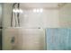 Bright shower features a glass enclosure, showerhead, grab bar, and convenient towel rack at 986 Se 57Th Ave, Ocala, FL 34480