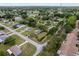 An aerial shot of a quiet neighborhood featuring mature trees, green lawns and well-kept homes at 10012 Sw 88Th Ct, Ocala, FL 34481