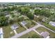 An aerial view of a residential area with tidy lawns and paved streets surrounded by lush greenery at 10012 Sw 88Th Ct, Ocala, FL 34481