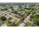 This aerial displays a serene neighborhood featuring lush trees and manicured lawns surrounding charming residences at 10012 Sw 88Th Ct, Ocala, FL 34481