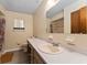 Bathroom featuring a long vanity with modern faucet, toilet, framed mirror, and shower/tub combo at 10012 Sw 88Th Ct, Ocala, FL 34481
