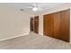 Bedroom featuring hardwood floors, a ceiling fan, and a large closet at 10012 Sw 88Th Ct, Ocala, FL 34481