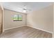 Cozy bedroom featuring wood floors, a ceiling fan, and a window with a view at 10012 Sw 88Th Ct, Ocala, FL 34481