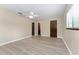 Bright bedroom with plank flooring, neutral walls, ceiling fan, and view of closet, bedroom door, and exterior at 10012 Sw 88Th Ct, Ocala, FL 34481
