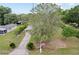 Bird's eye view of a well-maintained front yard with lush lawn, flag, and a quaint one-story home at 10012 Sw 88Th Ct, Ocala, FL 34481