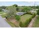 An aerial of a well-kept front lawn, trimmed evergreens and a charming one-story home at 10012 Sw 88Th Ct, Ocala, FL 34481