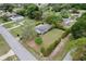 Aerial of a well-manicured lawn, neatly trimmed bushes, and a cozy single-story home at 10012 Sw 88Th Ct, Ocala, FL 34481