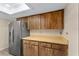 Kitchen featuring stainless steel refrigerator and ample cabinetry with countertops at 10012 Sw 88Th Ct, Ocala, FL 34481