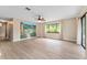 Living room with a ceiling fan, mural, and large windows at 10012 Sw 88Th Ct, Ocala, FL 34481