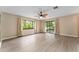 Bright living room featuring new wood floors and sliding glass doors for seamless indoor-outdoor living at 10012 Sw 88Th Ct, Ocala, FL 34481
