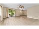 Spacious living room featuring wood floors and a ceiling fan for added comfort at 10012 Sw 88Th Ct, Ocala, FL 34481